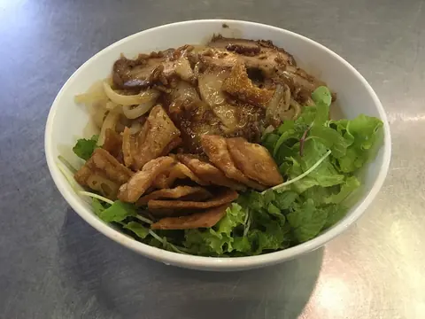 A bowl of Hội An’s cao lầu noodles with pork, greens and crispy croutons