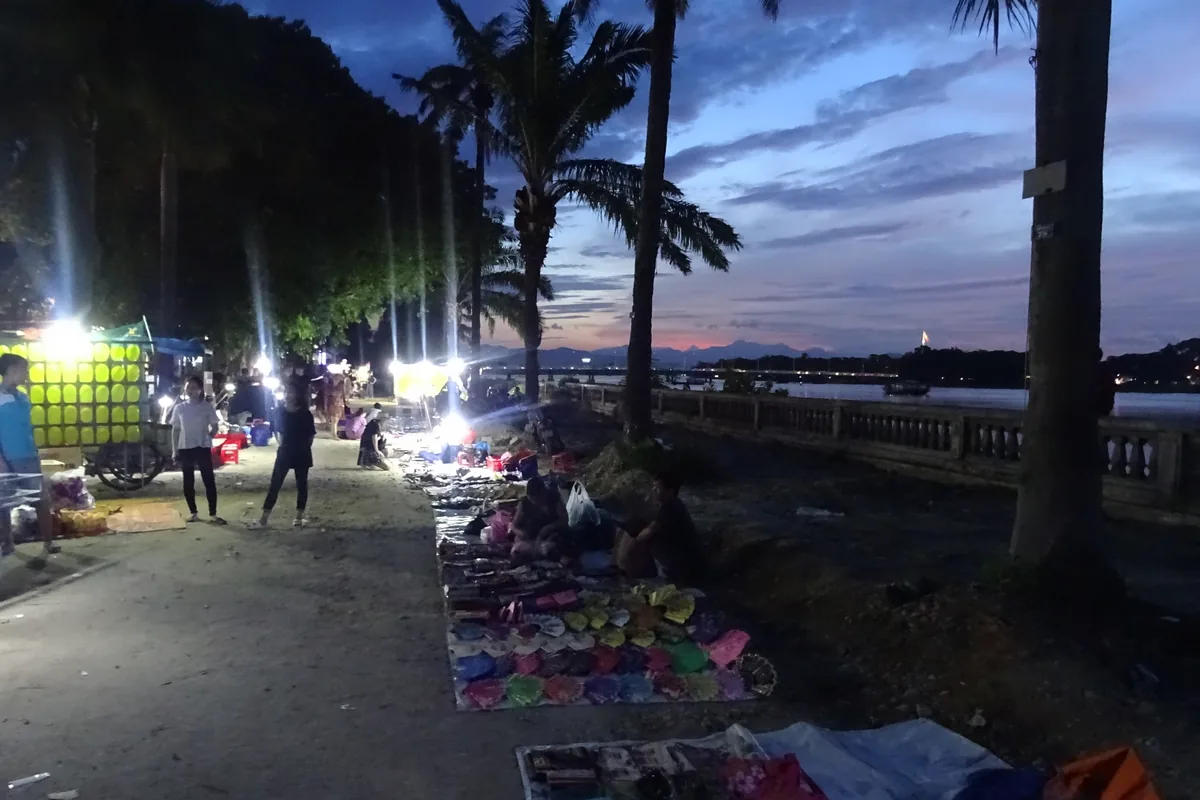 Lantern-lit stalls and shoppers at a Vietnam night market