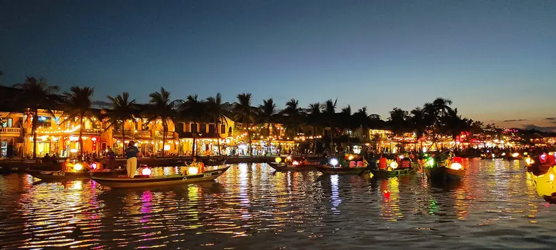 Hội An’s riverfront at dusk, lantern boats on the Thu Bồn River